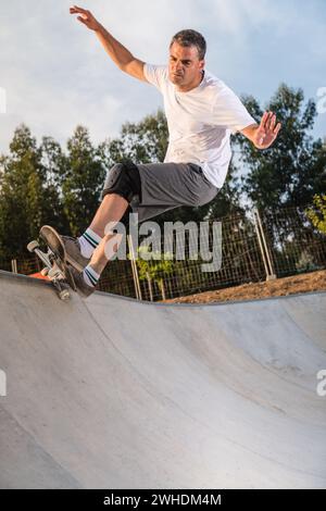 Skateboarder in a concrete pool Stock Photo