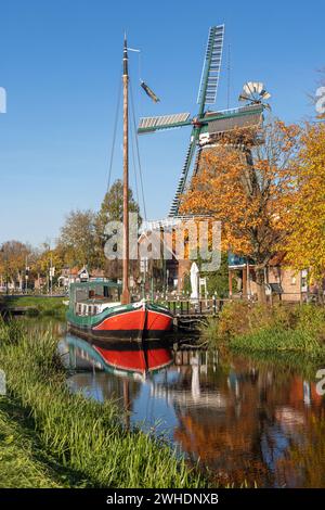 Autumn atmosphere, boat, windmill on the Großefehn Canal in Ostgroßefehn, East Frisia, Aurich district, Lower Saxony, Stock Photo