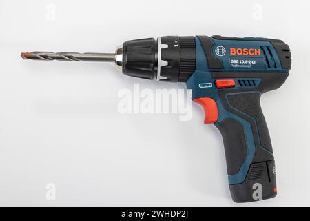 Cordless drill from Bosch, with inserted masonry drill bit, white background, Stock Photo