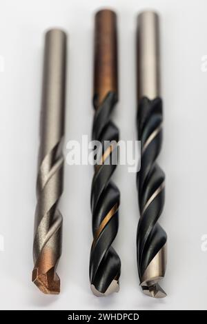 Three drill bits 10 mm, from left, masonry drill bit, metal drill bit, wood drill bit, white background, Stock Photo