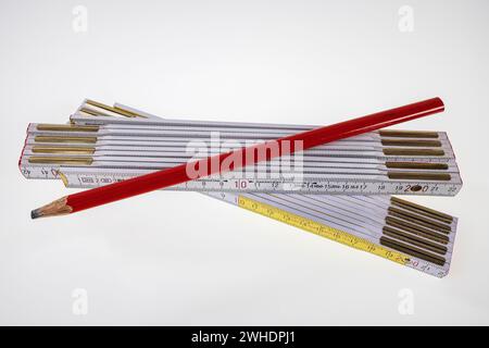Carpenter's pencil, two folding rules, folding ruler, white background, Stock Photo