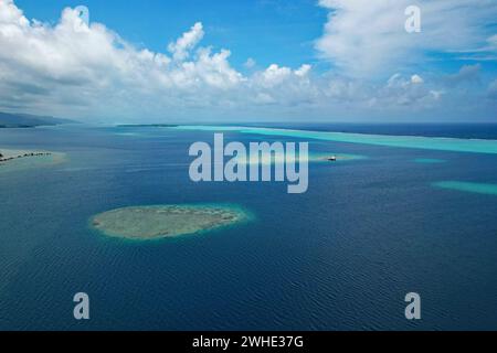 Aerial view of turquoise water and the coral reef in the South Pacific Ocean near the island of Raiatea on the south eastern coast of Raiatea Stock Photo