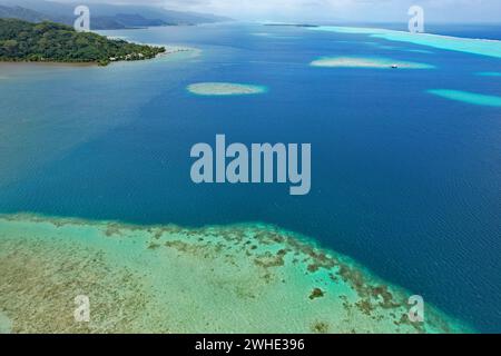 Aerial view of turquoise water and the coral reef in the South Pacific Ocean near the island of Raiatea on the south eastern coast of Raiatea Stock Photo