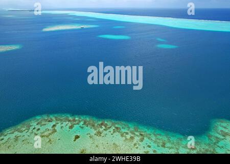 Aerial view of turquoise water and the coral reef in the South Pacific Ocean near the island of Raiatea on the south eastern coast of Raiatea Stock Photo