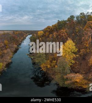 Aerial wide panorama of autumn river with mirror water, yellow forest landscape and cloudy sky. Wild riverside in Ukraine Stock Photo