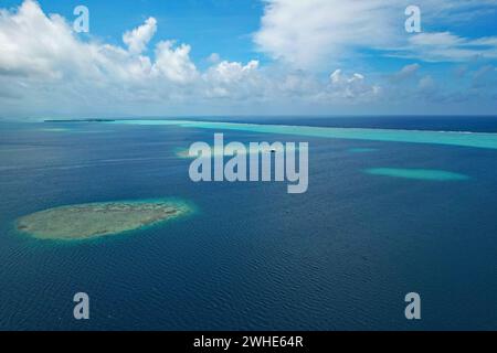 Aerial view of turquoise water and the coral reef in the South Pacific Ocean near the island of Raiatea on the south eastern coast of Raiatea Stock Photo