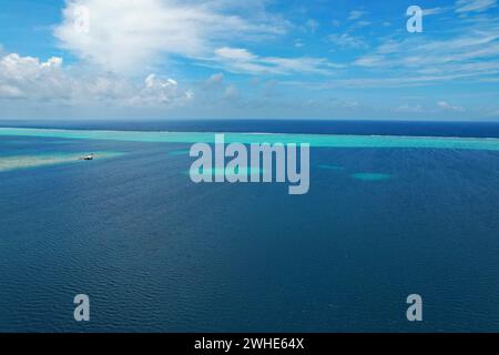 Aerial view of turquoise water and the coral reef in the South Pacific Ocean near the island of Raiatea on the south eastern coast of Raiatea Stock Photo