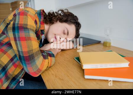 Photo of dreamy cute funky tired guy wear plaid shirt sleeping working table indoors room home house Stock Photo