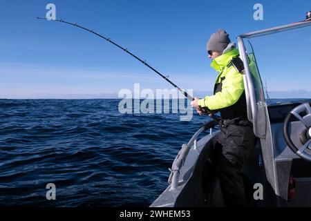 '02.04.2023, Norway, Northland, Andenes - Young man fishing in the Norwegian Sea. 00S230402D038CAROEX.JPG [MODEL RELEASE: YES, PROPERTY RELEASE: NO (c Stock Photo