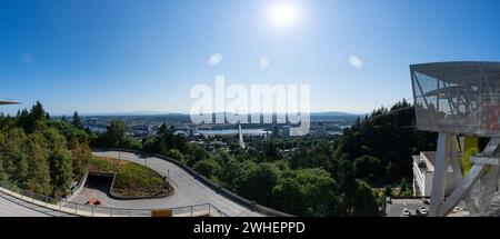 A panorama of the Portland Aerial Tram with the Portland Skyline and Mt. Hood in the background on a clear sunny summer day. Stock Photo