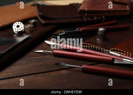 Leather samples and tools on wooden table Stock Photo