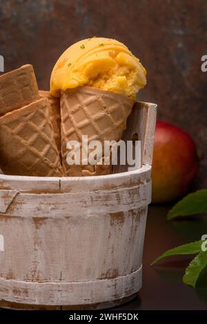 Homemade mango ice cream in waffle cone Stock Photo