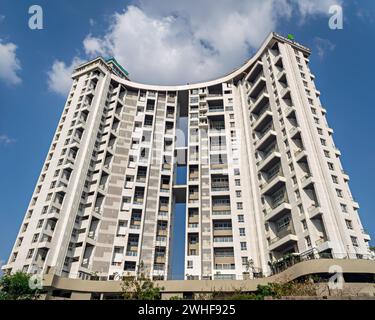 Pune, India-March 19th, 2023:Tall city building with a background of beautiful fluffy blue clouds sky in the background. Stock Photo