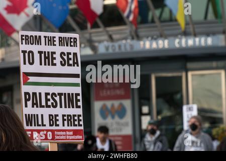 Seattle, USA. 9th Feb 2024. Protestor holding a sign that reads “From The River To The Sea” at the World Trade Center Offices on the waterfront for the Rally To End Israeli & US Genocide. Activists have been gathering for months calling for a ceasefire in Gaza. Rallies and protests have been worldwide following the recent chaos engulfing Gaza. Credit: James Anderson/Alamy Live News Stock Photo