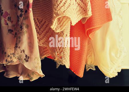 Women clothes hanging on racks in a boutique store Stock Photo