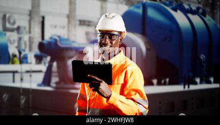 African Engineer Man Checking Industrial Facility. Osha Inspection Stock Photo