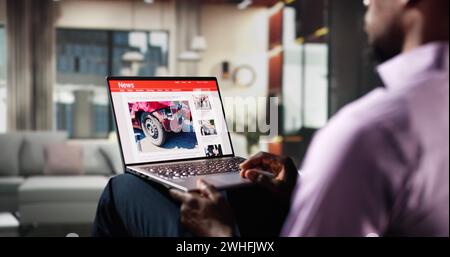 Watching News On Laptop Computer Screen Online At Home Stock Photo