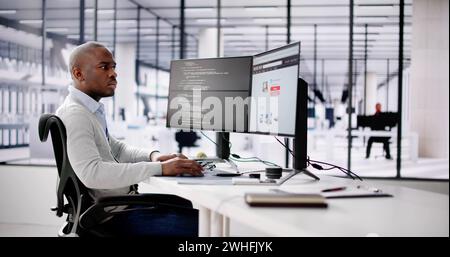 African Web Developer Programming Online Shop In Office Stock Photo