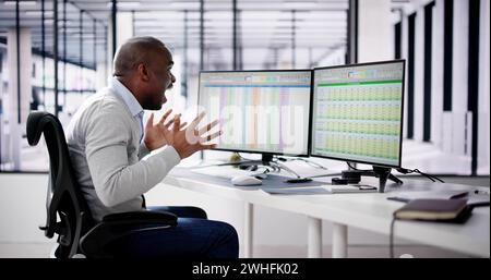 Data Analyst African Man Using Spreadsheet On Computer Stock Photo
