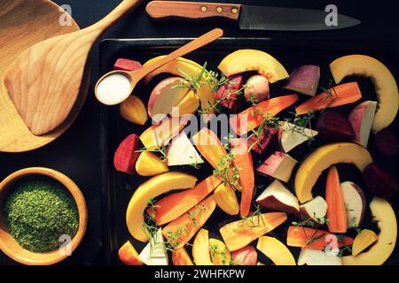 Top view of pan full of fall seasonal vegetables ready to be grilled over a dark background Stock Photo