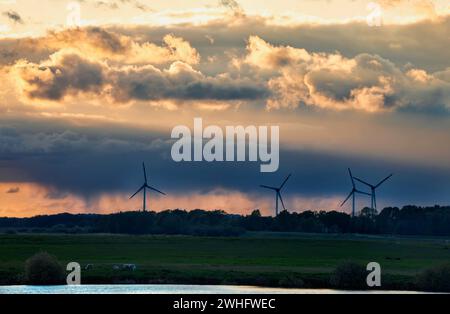 Turbines and dranatic rainy sky at sunset Stock Photo