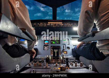Pilots in a cockpit in an airplane Stock Photo