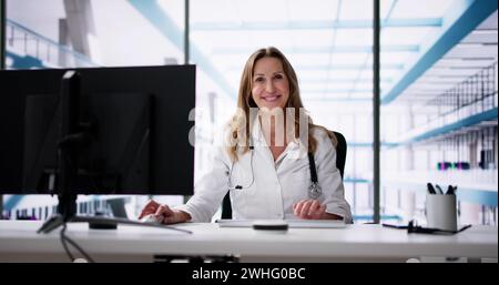 Medical Doctor Using Computer In Hospital. Lady Stock Photo