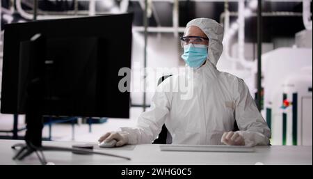 Sterile Semiconductor Manufacturing Factory And Worker In Coverall Stock Photo