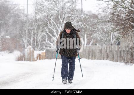 A nordic hiker in wintry scenes from Braemar as parts of Scotland are under a yellow Met weather warning for snow and ice.  Credit: Euan Cherry Credit: Euan Cherry/Alamy Live News Stock Photo