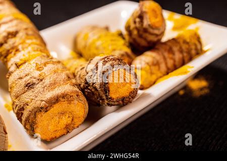 Ginger Roots on a dark background. Stock Photo