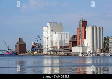 Flensburg, Germany, July 25, 2022:  Industrial city port with storage buildings and silos on the Flensburg fjord on the Baltic S Stock Photo
