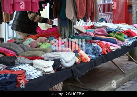 Colorful warm clothes for sale in a stall at an autumn and winter market around Christmas Stock Photo