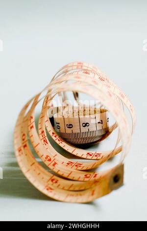Tape Measure isolated on blue background Stock Photo