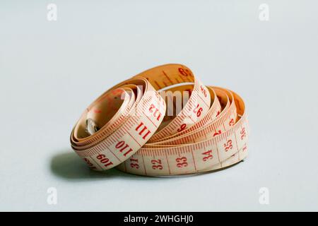 Tape Measure isolated on blue background Stock Photo