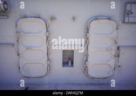 Grungy rusty steel hatch doors secured with nuts and bolts. Stock Photo