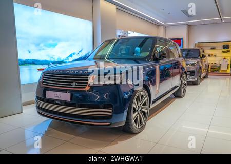 Land Range Rover blue in the showroom on the shop showcase exhibition of an official dealer. Thailand, Bangkok 21 december 2023. Stock Photo