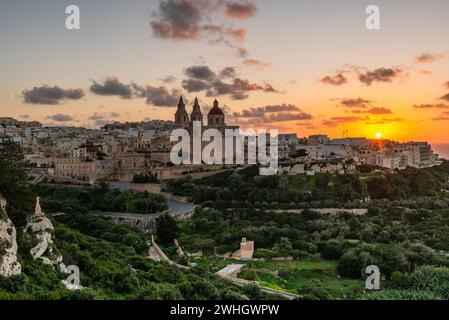 Il-Mellieha, Malta - skyline view of Mellieha town at sunset with Paris Church on hill top Stock Photo