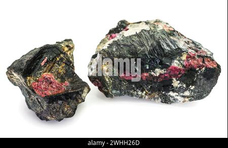 Two pieces of rock interspersed with the mineral eudialyte on a white background Stock Photo