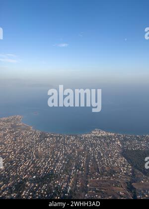 Aerial view of the city by the sea against the blue horizon Stock Photo