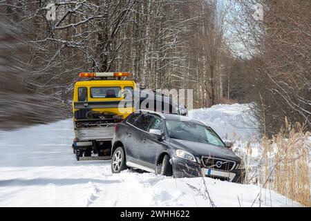 Winter accident of a black car that slid off the road and killed the rescue vehicle Stock Photo