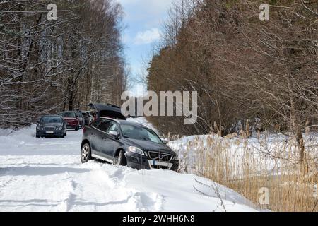 An accident of a black car in winter, which slid off the road Stock Photo