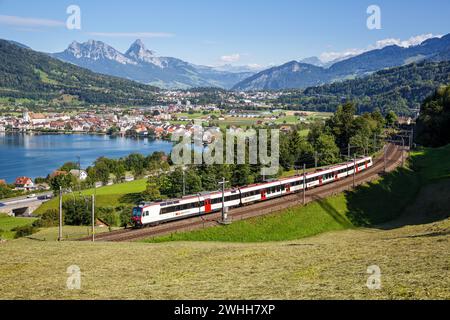 Arth, Switzerland - August 10, 2023: Railway Passenger Train Of The Swiss Federal Railways SBB At The Mountain Grosser Mythen Am Zugersee In The Alps Stock Photo