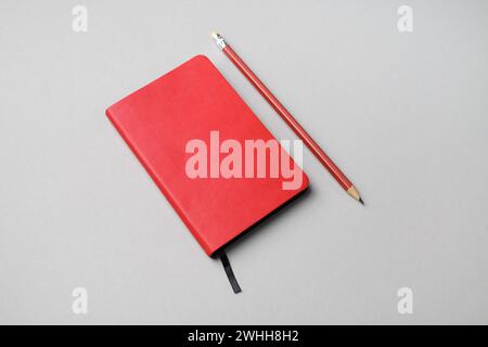 Red notebook and pencil Stock Photo