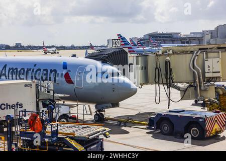 Close-up view of American Airlines plane at Miami Airport, connected to boarding ramp for passenger embarkation. Miami. USA. Stock Photo