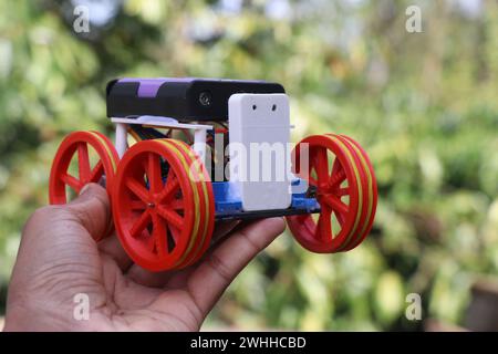 STEM robot or also called as Robotic car that is built for learning electronics and programming held in hand. Working model of robotic vehicle Stock Photo