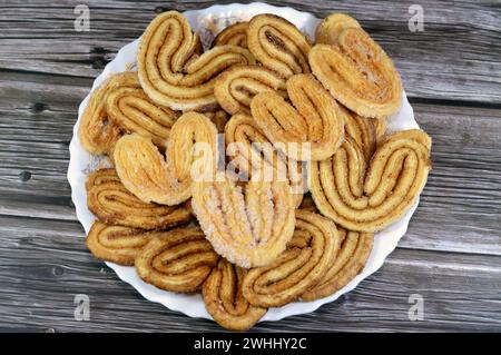 palmier, short for feuille de palmier 'palm tree leaf, French hearts cookies, Palmiers are made from puff pastry, a laminated dough similar to the dou Stock Photo