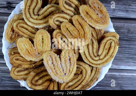 palmier, short for feuille de palmier 'palm tree leaf, French hearts cookies, Palmiers are made from puff pastry, a laminated dough similar to the dou Stock Photo