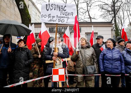 Warsaw, Poland, 10th of February, 2024. A crowd of people, holding Polish national flags and anti-government banners, led by far right media - Gazeta Polska and TV Republica and Law and Justice (Prawo i Sprawiedliwość - PIS) political party leaders stage a protest in support of current Constitutional Court Judges in front of the Court's building on Szucha Street. Poland goes through a constitutional crisis as current, centrist government says judges of Constitutional Court were illegally installed by former right-wing government. Right-wing opposition demonstrates a support of the Court Judges Stock Photo