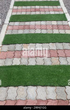 garden path made from grey bricks and green grass Stock Photo