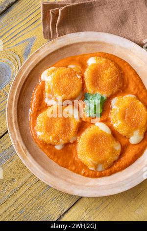Nuggets with melted camembert with bell pepper sauce Stock Photo